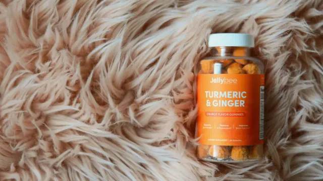 A jar of elderberry gummies sitting beside a dog supplement bottle on a kitchen counter