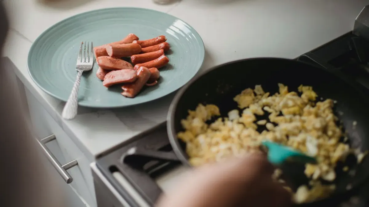 A small portion of plain scrambled egg served on top of a dog's kibble