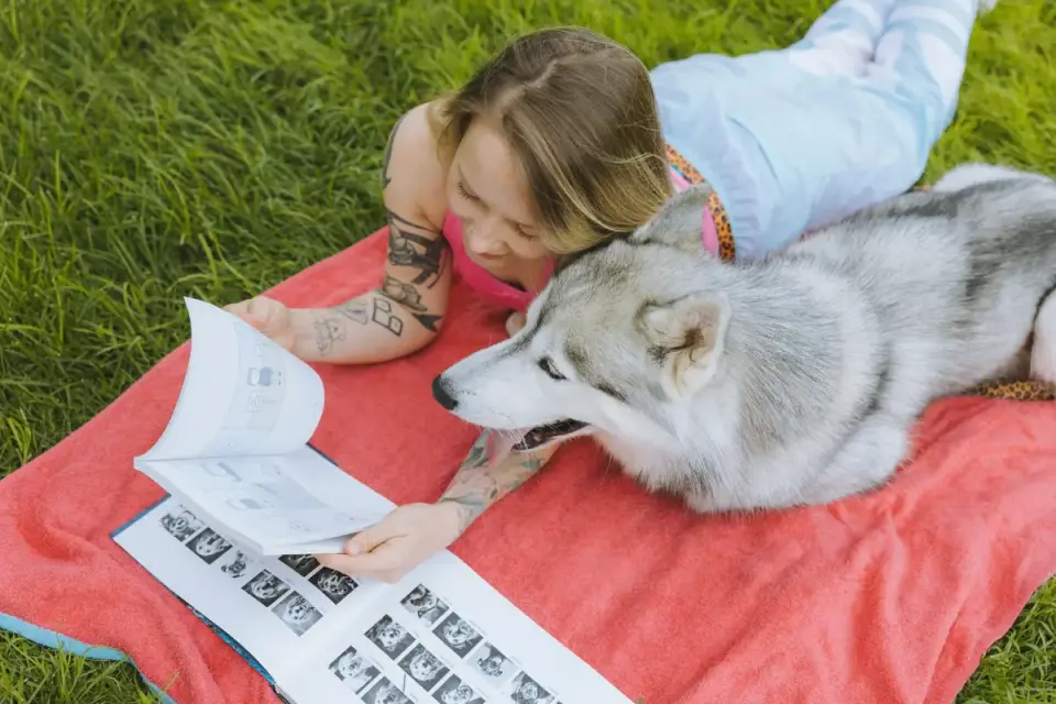 A veterinarian examining a dog supplement&#x27;s ingredient panel next to a dog on the exam table