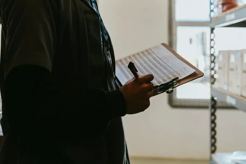 A veterinarian reviewing quality-control paperwork in a supplement manufacturing setting