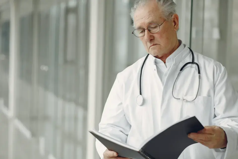 A veterinarian reviewing a supplement bag&#x27;s ingredient panel next to a senior dog