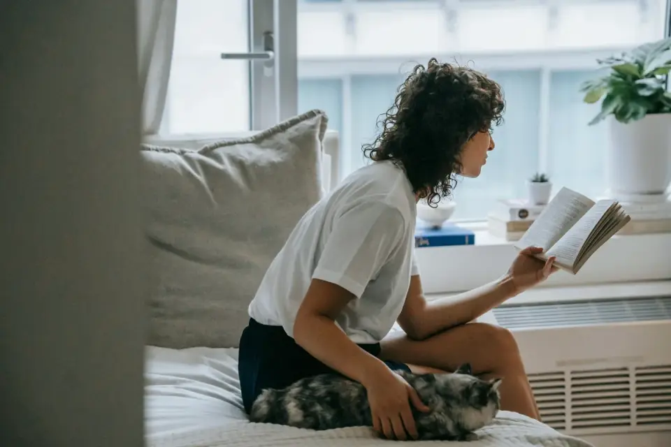 An owner reading the ingredient panel on a supplement bottle before giving it to a dog