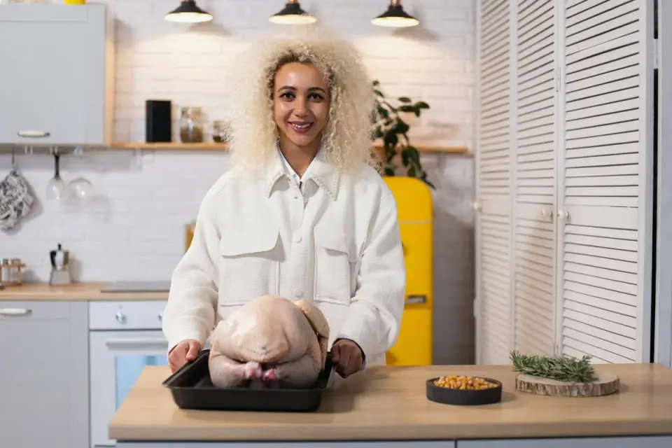 Dog sniffing at a turkey carcass left on a kitchen counter