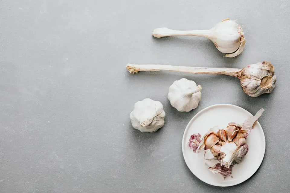 Onions and garlic bulbs stored away from a dog&#x27;s reach in a closed pantry